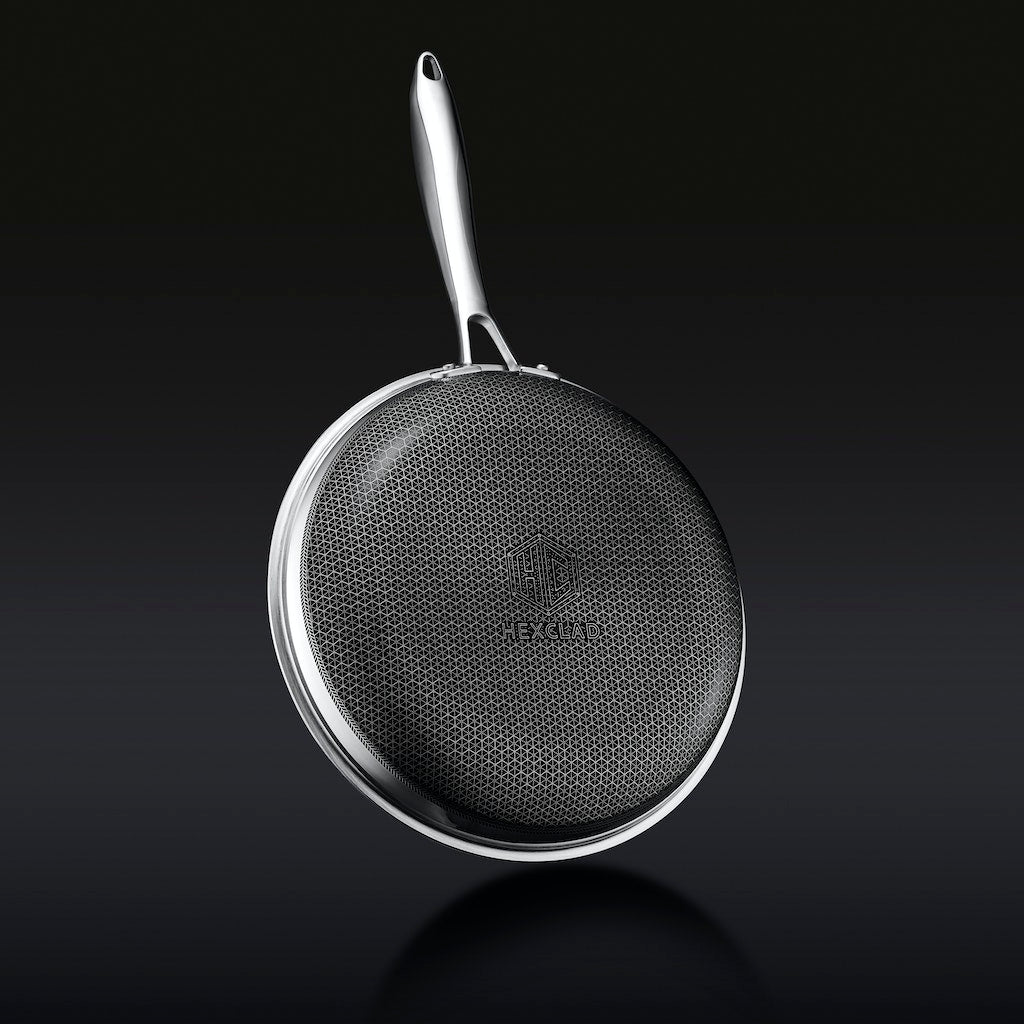 A skillet with baked mac and cheese, topped with breadcrumbs and fresh herbs.